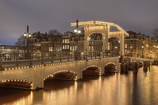 阿姆斯特丹的瑪格爾橋(Magere Brug，或譯為瘦橋)。起義其間的阿姆斯特丹，是個有趣的市鎮。即便在加入起義軍後，阿姆斯特丹的商人仍會因為商利，輸送資源給受困的西班牙軍隊，以換取黃金。